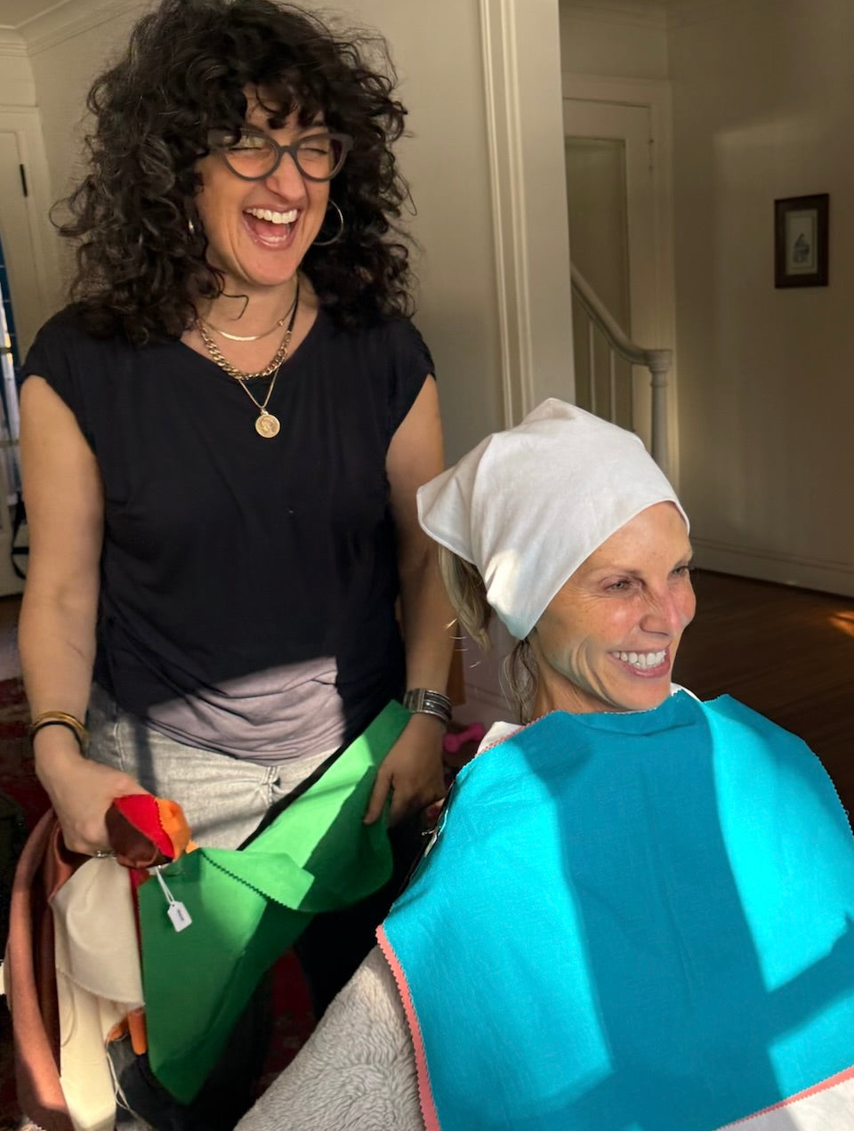 Sara Silvio laughing during color analysis session draping a True Spring client with International Image Institute color drapes — The Full Picture