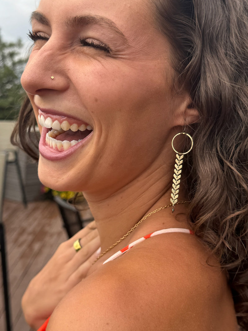 Woman in warm autumn palette wearing Sara Silvio earrings
