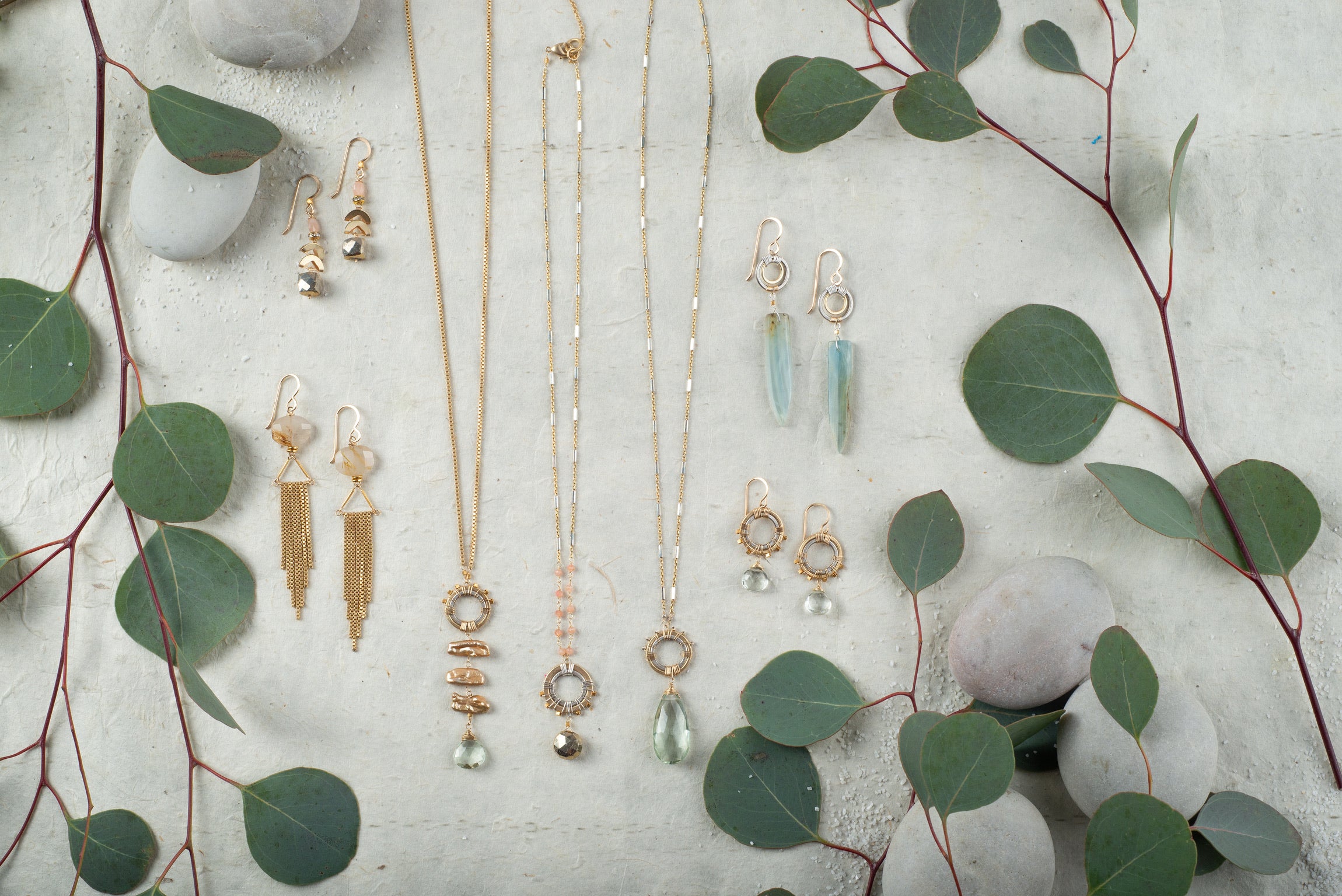 collection with gold mutilated fringe earrings and green amethyst necklaces